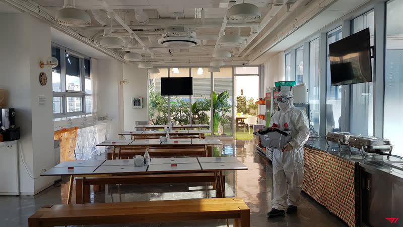 Health workers conduct checks and disinfect at T1 headquarters after detecting a positive case there